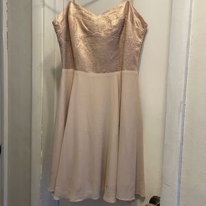 This semi formal dress is a tan and rose gold color.